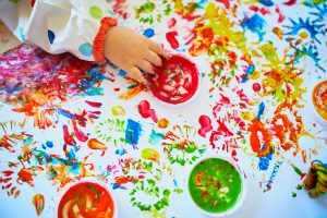 Hand of little girls painting with fingers at home, in kindergaten or preschool. Creative games for kids