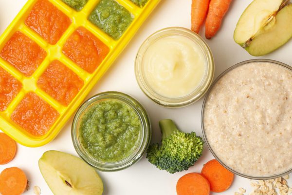 Composition with baby food on white background, top view Composition with baby food on white background, top view