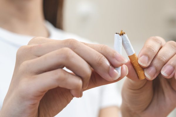 Close up hands of person refusing to smoke cigarette.