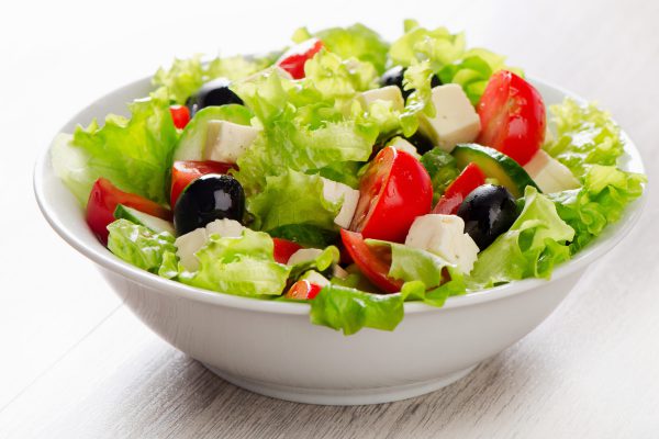 Fresh vegetables salad with feta, olives . Selective focus